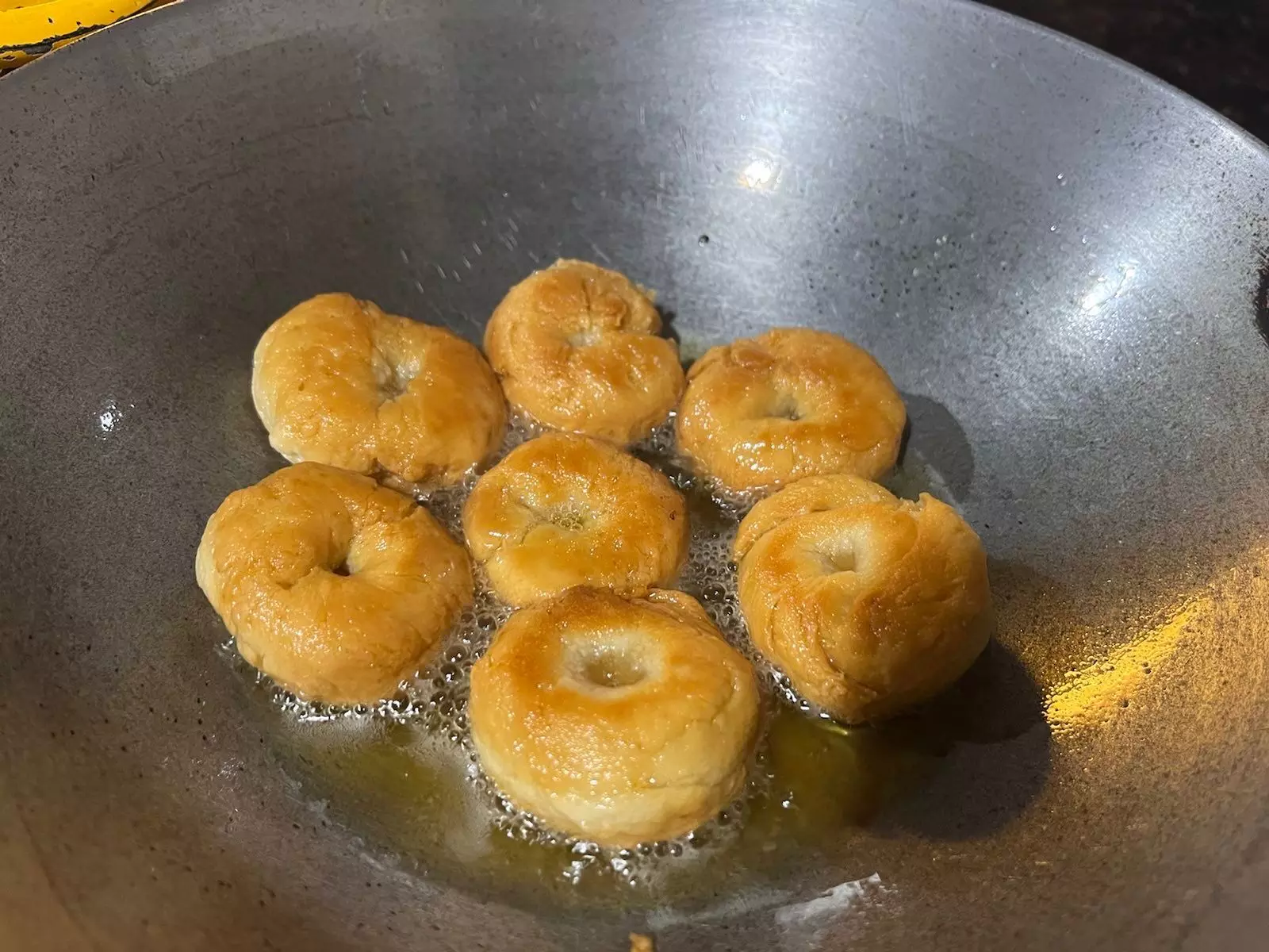 Take the balushahi out once they are light brown and straight away dip them in warm sugar syrup.