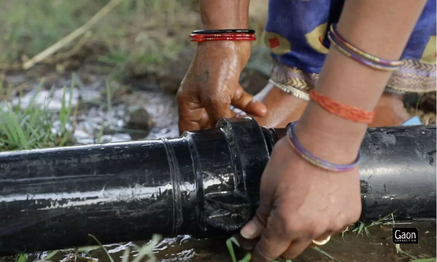 Laxmi Devi fits the pipes, without any help from the males of her family, to irrigate her fields in Tindouli, Mahoba, Uttar pradesh.